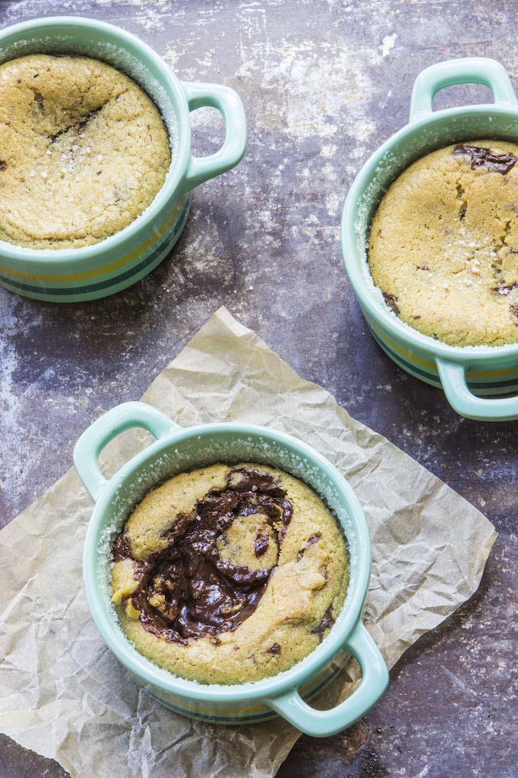 These molten chocolate chip cookie lava cakes consist of a soft, chocolate studded cookie filled with a gooey chocolate surprise.