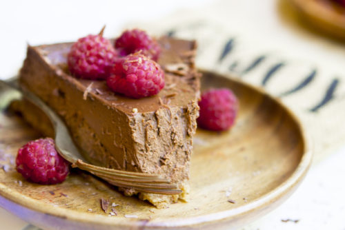 a slice of delicious mocha cheesecake topped with berries