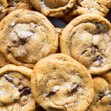 a bird's eye view of chocolate chip cookies piled over each other.