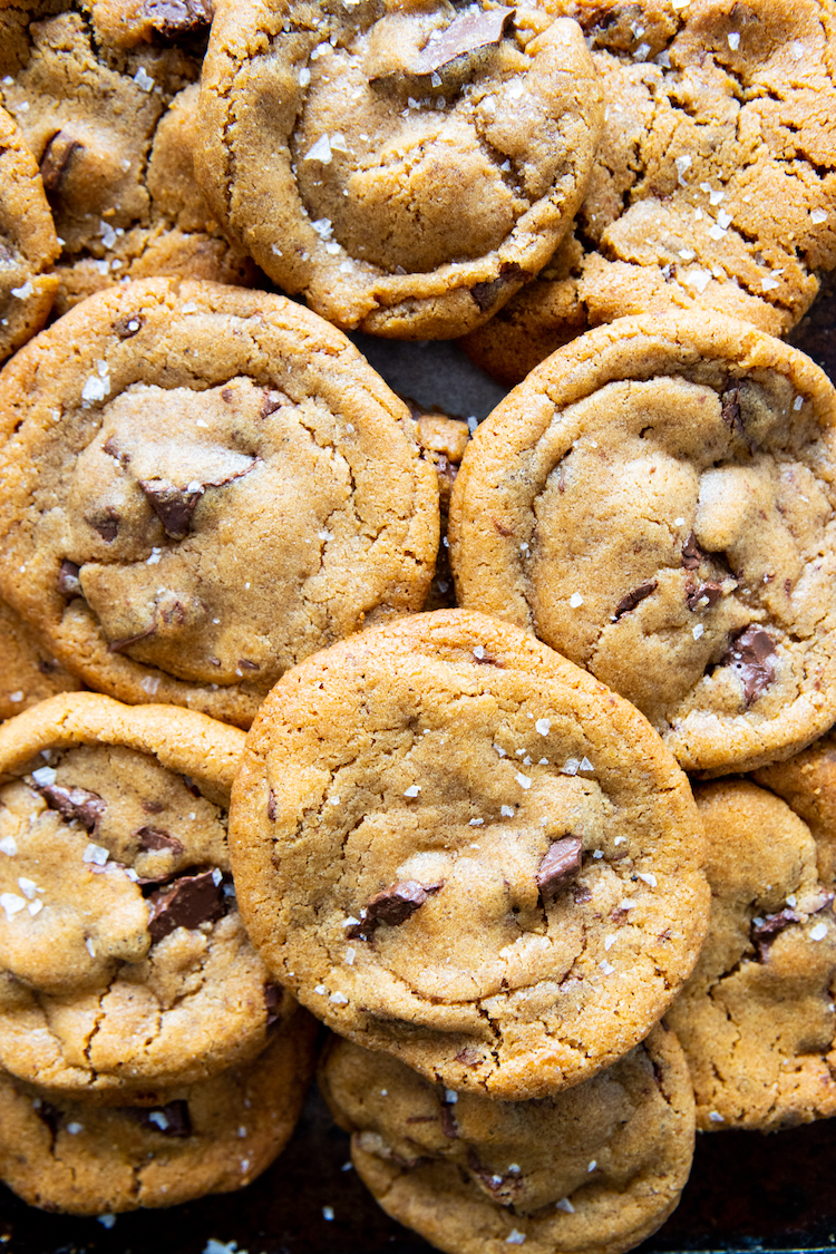 a bird's eye view of chocolate chip cookies piled over each other.