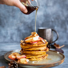 pouring syrup onto a stack of pumpkin pancakes (centre).