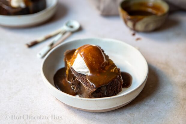 Picture of chocolate sticky toffee pudding piece with ice cream and toffee sauce