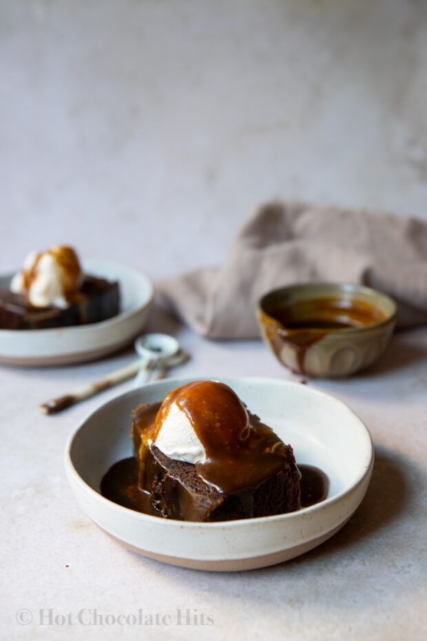 Picture of chocolate sticky toffee pudding piece with ice cream and toffee sauce
